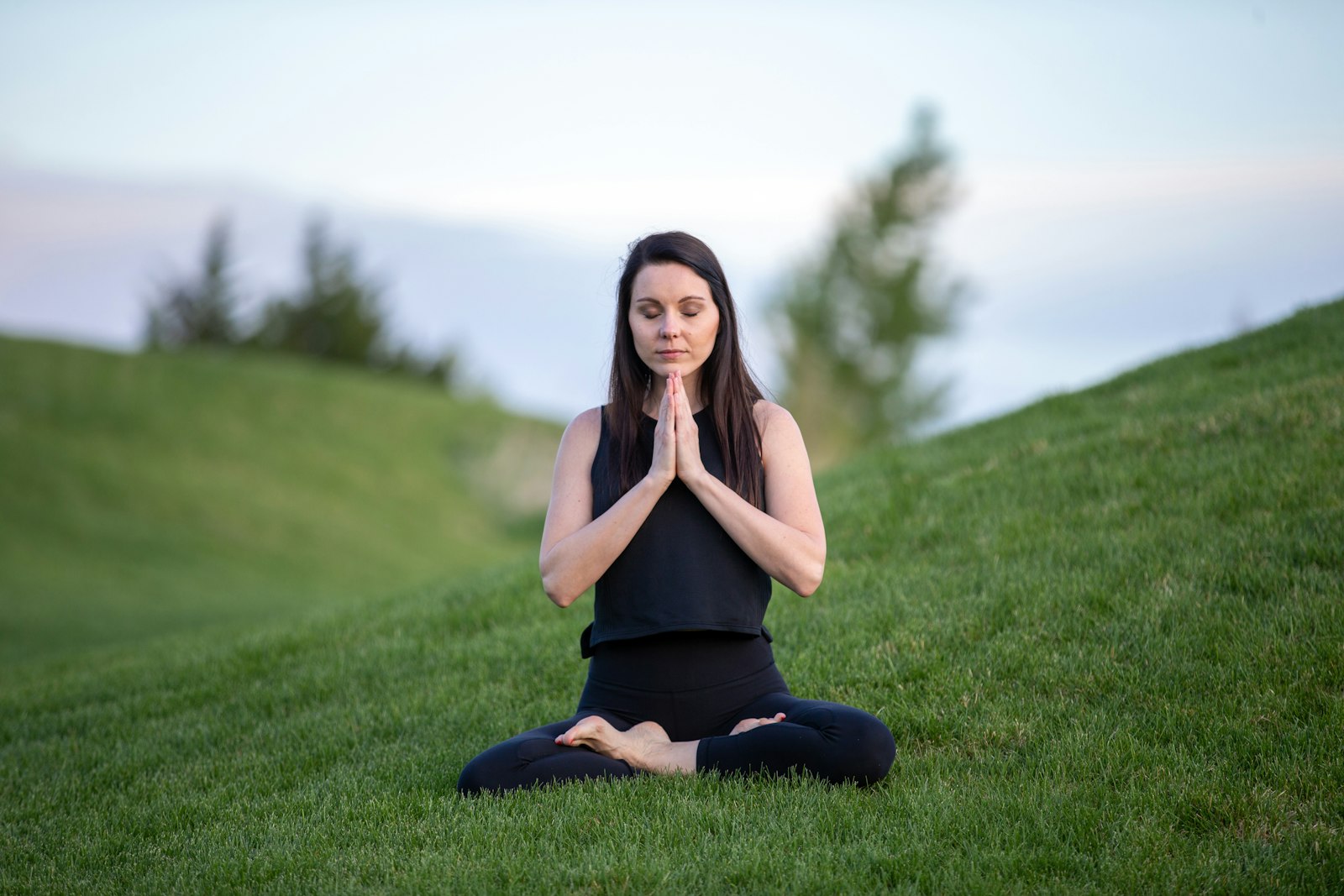 A person meditating peacefully outdoors